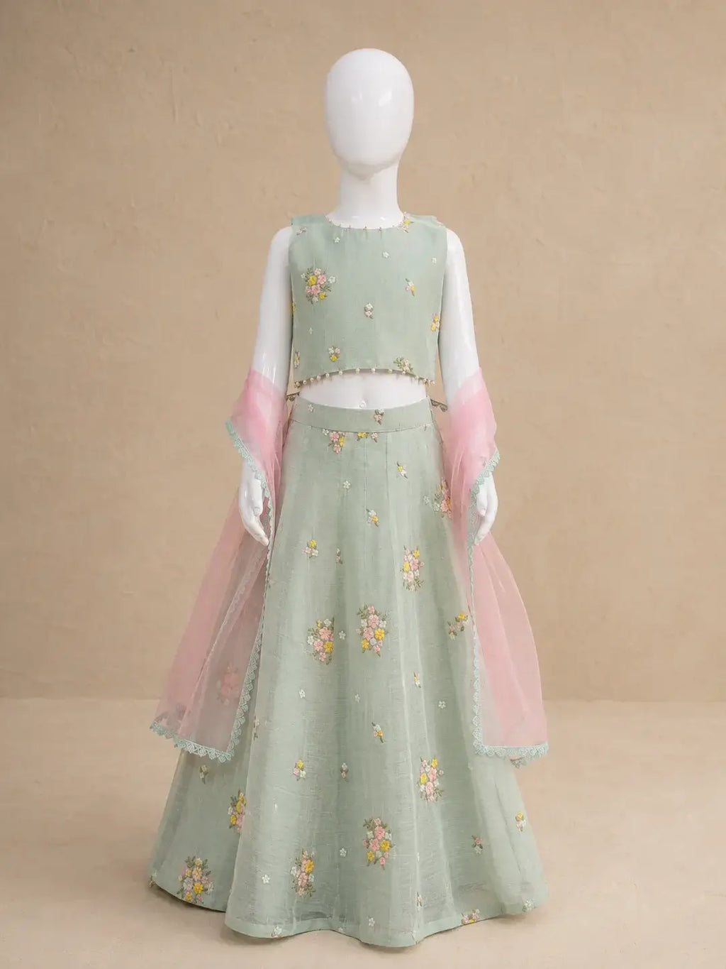 Pastel floral lehenga set for girls by Marwar Roots, featuring intricate embroidery and flowing fabric in vibrant colors.