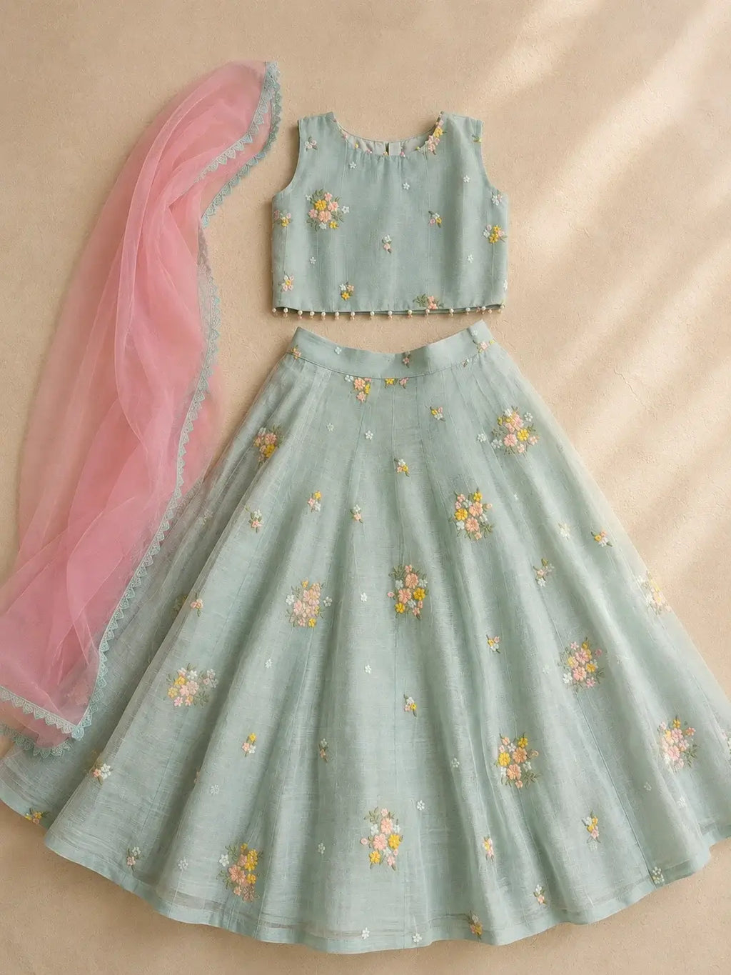 Aarohi pastel floral lehenga set for girls by Marwar Roots, featuring intricate embroidery and a flowing skirt.