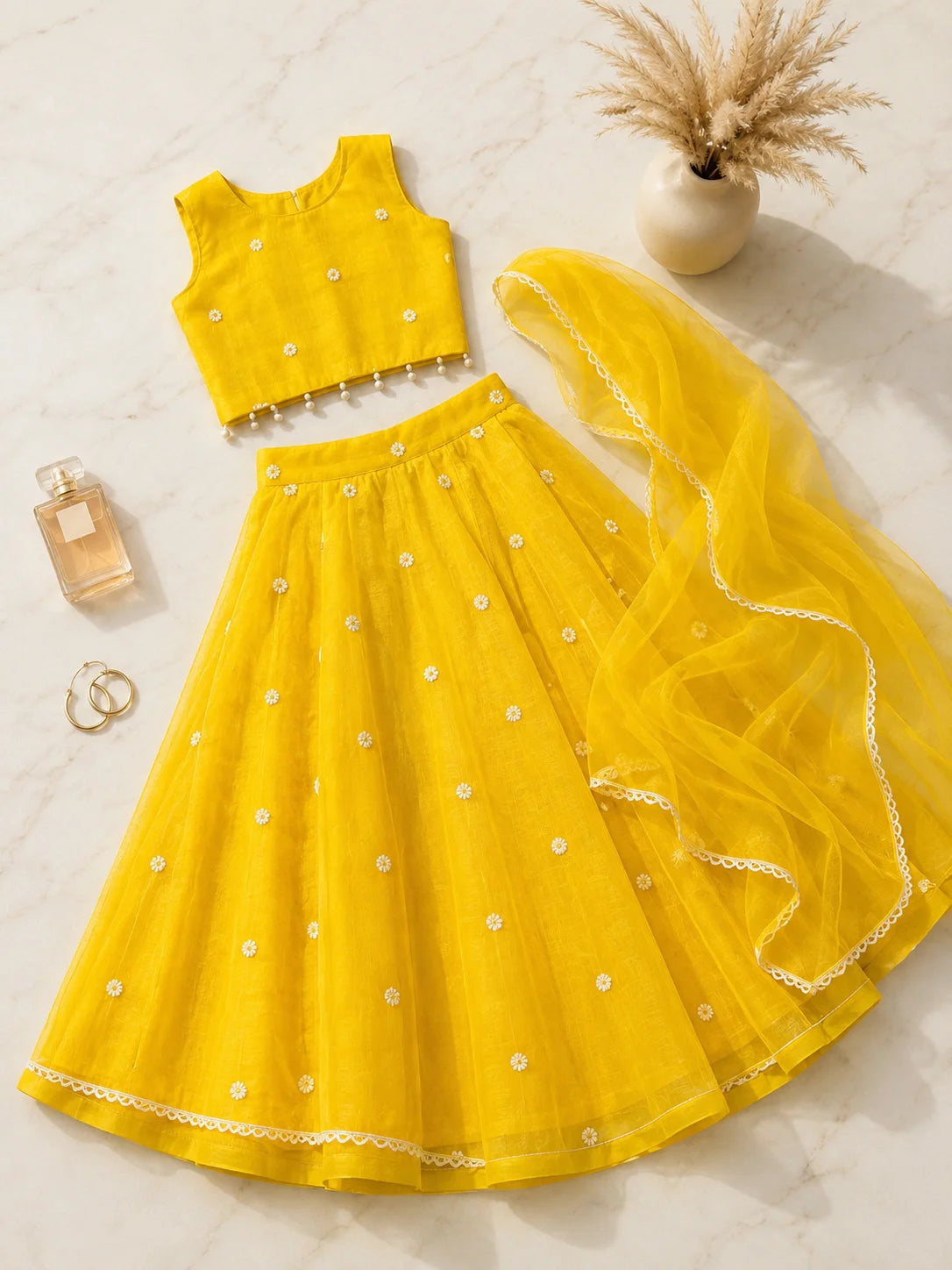 Yellow floral girls lehenga choli set with dupatta and pearl tassel detailing