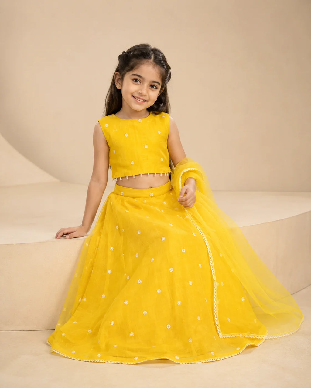 Yellow floral girls lehenga choli set with dupatta and pearl tassel detailing