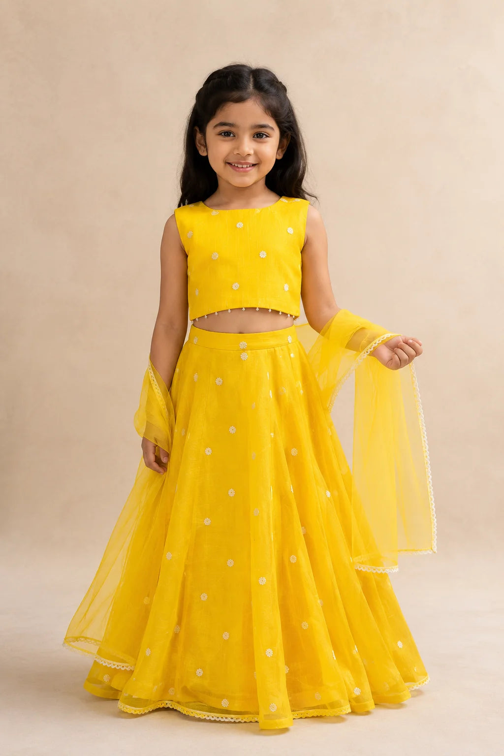 Yellow floral girls lehenga choli set with dupatta and pearl tassel detailing