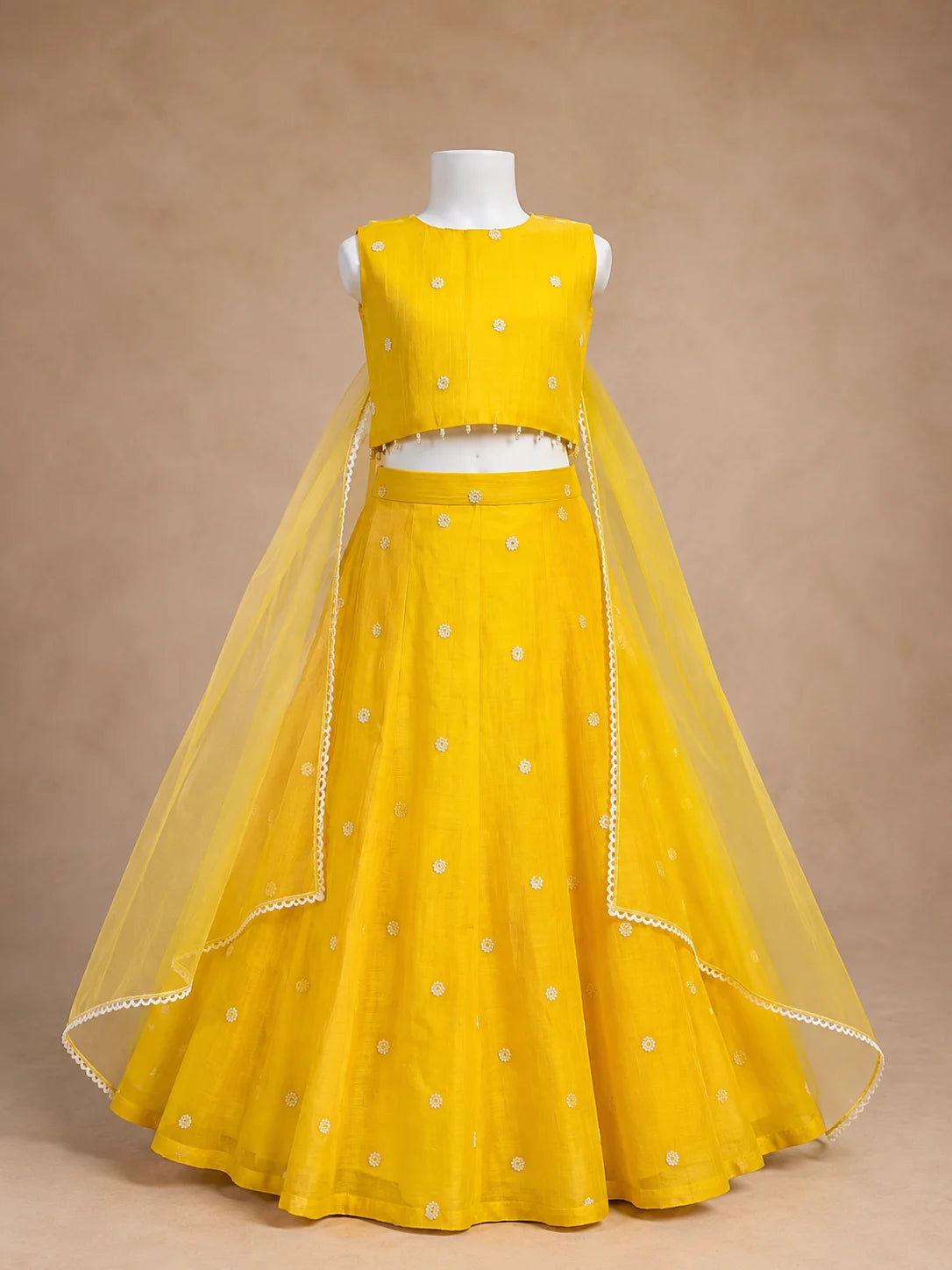 Yellow floral girls lehenga choli set with dupatta and pearl tassel detailing