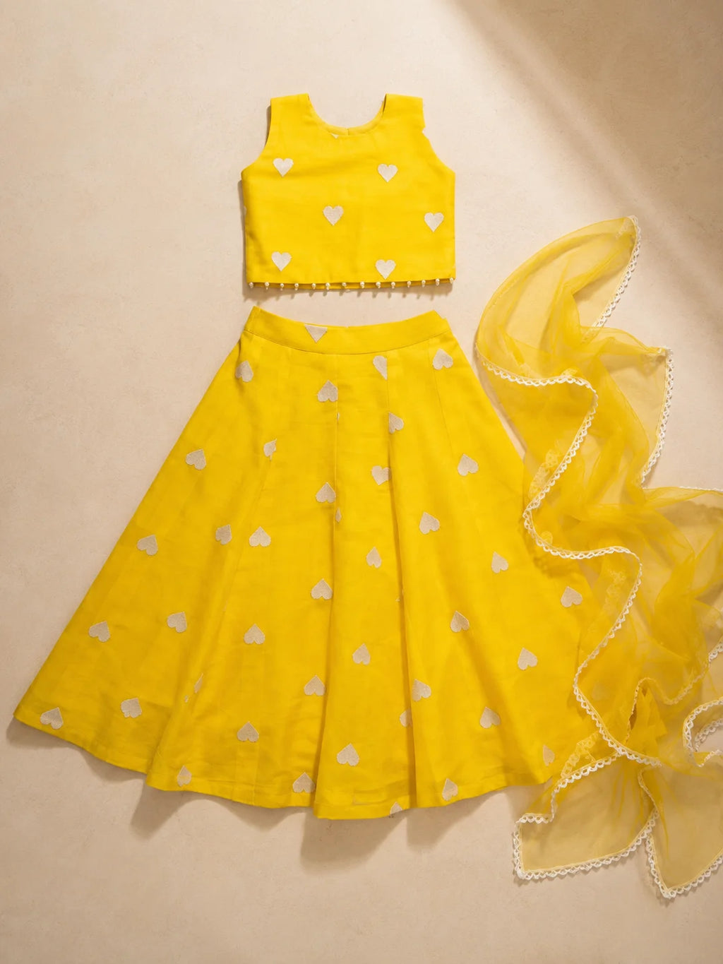 Yellow heart-patterned Lehenga Set by Marwar Roots featuring intricate embroidery and vibrant fabric for festive occasions.