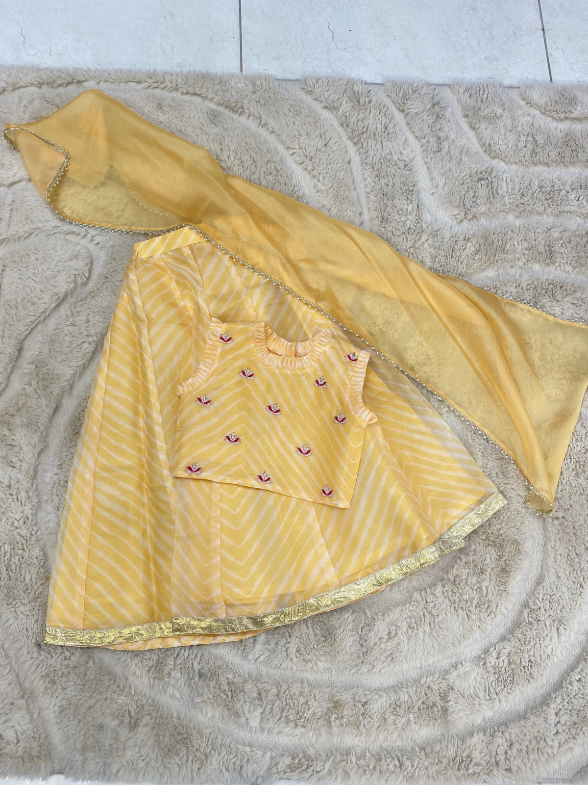 Girls sunshine yellow striped lehenga set with embroidered sleeveless blouse and sheer dupatta