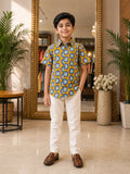 Boy wearing mustard yellow Surya motif printed half sleeve shirt with ivory trousers