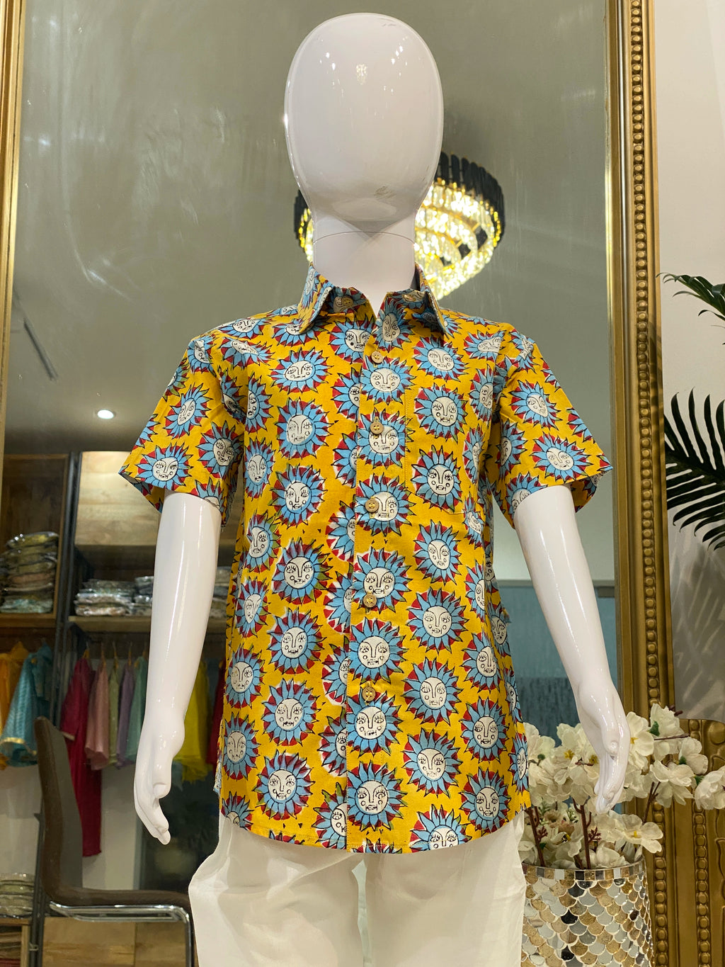 Boy wearing mustard yellow Surya motif printed half sleeve shirt with ivory trousers