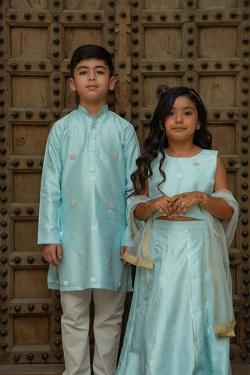Blue heart twinning boy kurta set and girl lehenga set by Marwar Roots, perfect for siblings' special occasions.